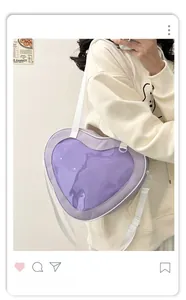 Detail view of purple heart-shaped ita bag with clear window and white canvas strap