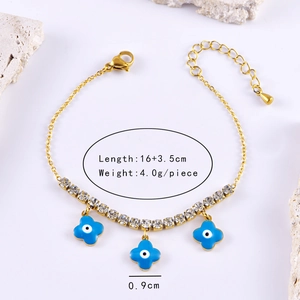 Detailed shot of golden clover bracelets with blue evil eye stones and clear crystals