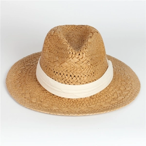 Close-up of the natural woven straw texture and white fabric band on the Panama hat