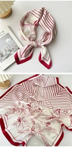 Detail of red and white silk scarf showing floral pattern and geometric stripe textures