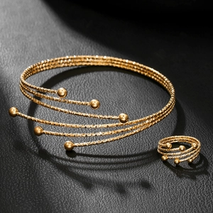 Minimalist gold multi-layer spiral bracelet and ring jewelry set with metal bead details