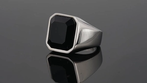 Detailed view of men's vintage steel signet ring with rectangular black gemstone