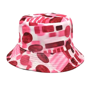 Close-up of pink bucket hat featuring abstract geometric patterns and colorful dots
