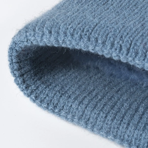 Thick blue ribbed knit winter hat with warm grey fleece lining for cold protection
