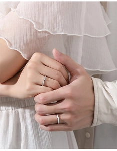 Close-up of S925 sterling silver couple rings showing the male and female minimalist bands