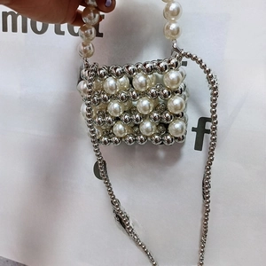 Detail of handmade mini beaded bag featuring pearl texture beads and silver metal chain