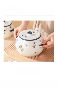 Close-up of heat-resistant ceramic lard jar with vintage blue floral patterns and lid