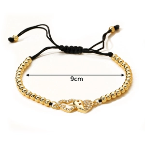 Adjustable woven black rope bracelet with gold beads and sparkling zircon heart pendants