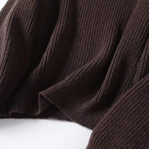 Close-up of dark brown ribbed knit fabric texture showing detail of thick elastic material
