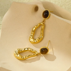 French style stainless steel geometric gold earrings with cat eye stones in macro view