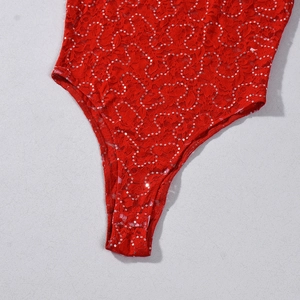 Close-up of vibrant red lace dress with detailed silver sequins and fine textures