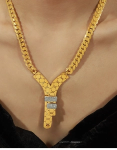 Close-up of golden 18k gold-plated Y-shaped pendant necklace with zircon on a model