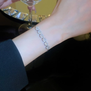 Detail of adjustable silver bracelet with pavé cubic zirconia circles on wrist