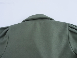 Detail view of military green wool coat back featuring puff sleeves and tailored collar
