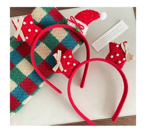 Detail of red Christmas headbands with sequins stars and pearls on festive fabric background