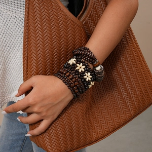 Bohemian multi-layer wooden bead bracelet with coconut shells worn by a model