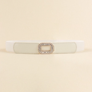 Close-up of white elastic waist belt with a golden rhinestone rectangular buckle detail