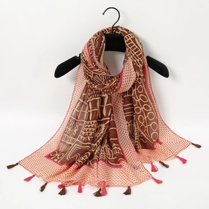 Detail of soft warm shawl with artistic ink wash butterfly print and fringed edges