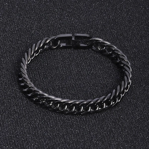 Macro detail of black stainless steel Cuban chain link with engraved steel hallmark