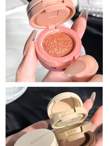 Close-up of three-color eyeshadow palette with shimmering orange gold and matte beige tones
