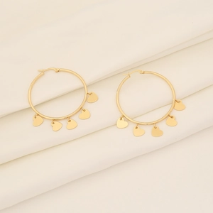 Elegant gold hoop earrings with five heart-shaped pendants on silk background