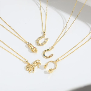 Vintage gold necklaces with lion and horseshoe pendants on a white background