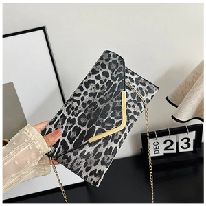 Close-up of leopard print envelope clutch with V-shaped gold metal trim and chain strap