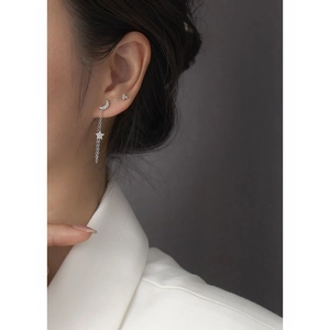 Close-up of S925 silver star and moon tassel earrings with sparkling cubic zirconia