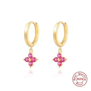 Detail of S925 sterling silver gold earring with four pink zircon stones in flower shape