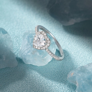 Macro shot of silver heart ring with micro diamonds on ice-like display props