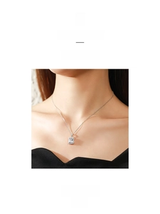Detail of 925 sterling silver necklace featuring a rectangular zircon pendant on a model