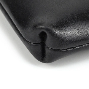 Close-up of black genuine leather wallet with fine stitching and natural grain texture