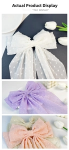 Detail of oversized Swiss dot chiffon bow clips in white, purple and peach
