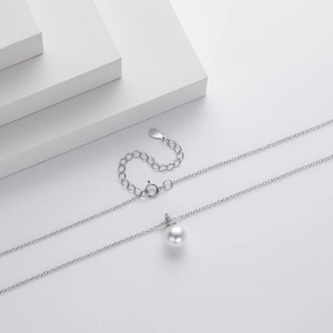 Detail of S925 sterling silver chain with a round white pearl pendant and adjustable tail