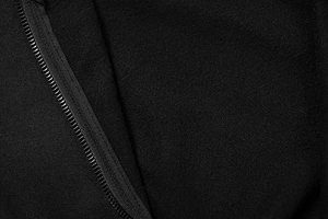 Detailed macro view of the sleek black front zipper on a sporty American style hoodie