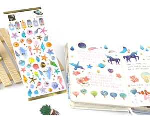 Detail of ocean and starry sky stickers with gold foil used in a daily planner