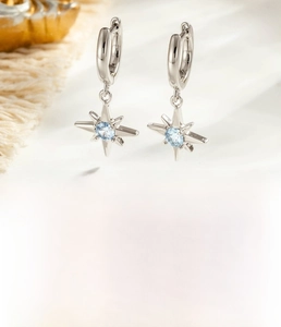 Detail of silver starburst hoop earrings with light blue zircon inlay and dimensions