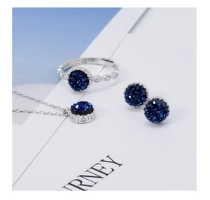 Detailed view of silver jewelry set with dark blue round druzy stones and twisted ring band