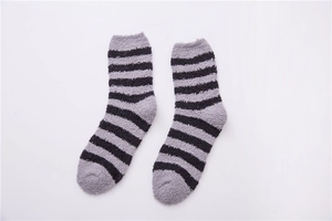 Detailed view of grey and black striped coral fleece socks with plush textured material