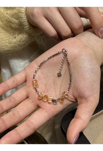 Detail of S925 sterling silver bracelet with yellow citrine beads and star charm