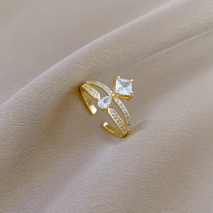 Adjustable gold crown ring with square and water drop zircons on textured fabric