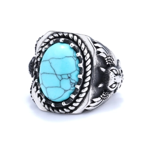 Detail of vintage eagle ring featuring oval turquoise stone and engraved silver finish
