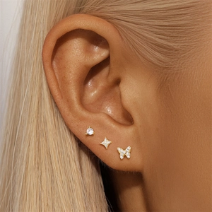 Detail showing S925 silver stud earring set with butterfly and star-shaped zircons