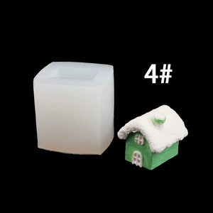 Macro view of house-shaped silicone mold and green 3D cabin candle finish on black background