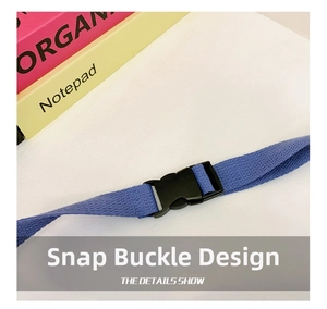 Detail of durable black plastic buckle on navy blue woven strap for kids waist bag