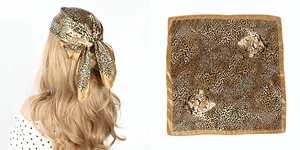 Detail of leopard print satin square hair scarf showing full pattern and styling as a headwrap