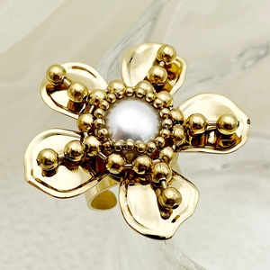 Gold flower ring with central pearl and small zircon beads on an adjustable band