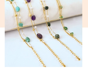 Detail of bohemian gold chains with colorful stones, pearls and adjustable clasps