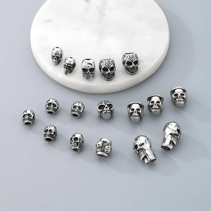 Detailed macro view of various stainless steel skull beads for DIY jewelry making