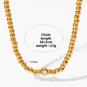 Detail of gold beaded necklace with central zircon stone featuring 3.7mm beads and 38cm chain